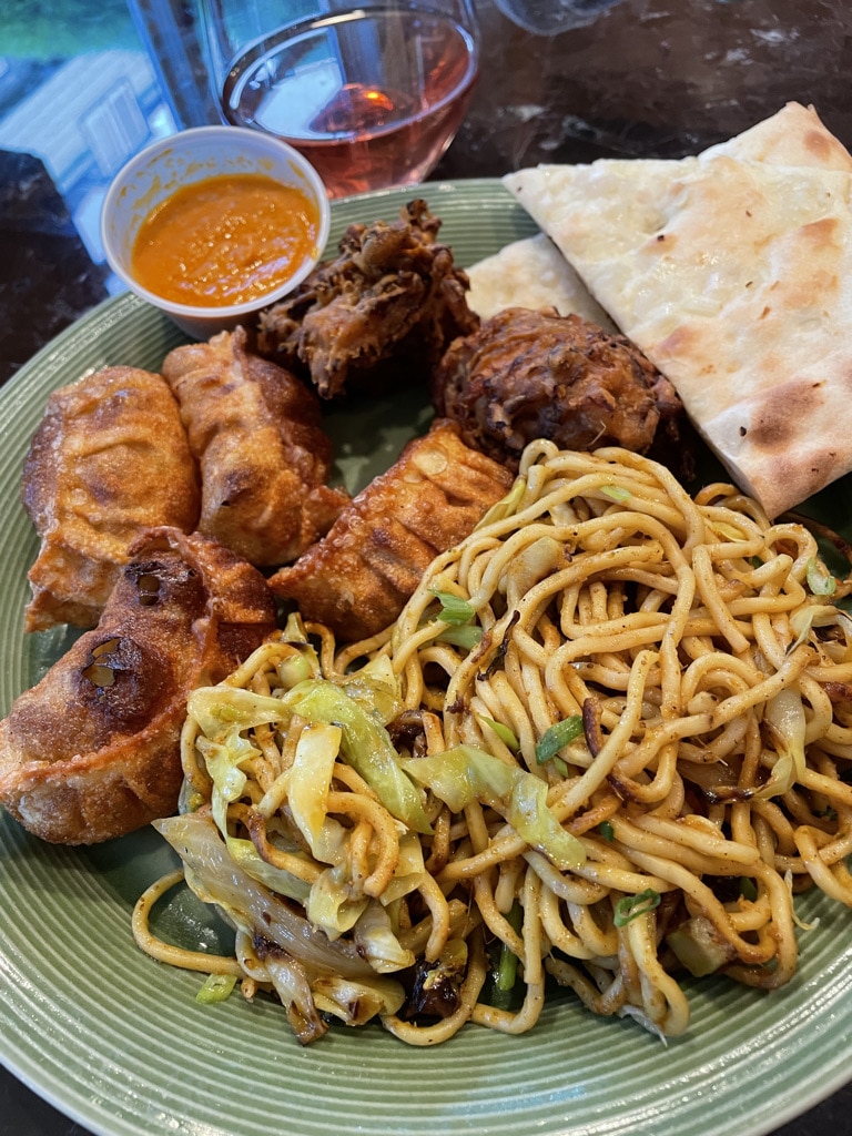 Center Himalayan Noodles, Clockwise: momos, pikora and Naan